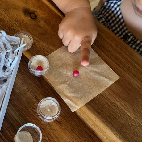 Child taking her fingerprint impression on wax