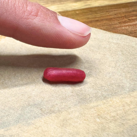 Clos up of person leaving fingerprint impression in wax