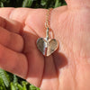 Gold fingerprint necklace in the palm of a hand
