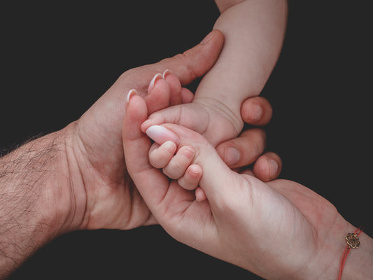 Close up of family holding hands