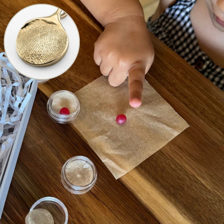 Child leaving fingerprint impression in wax