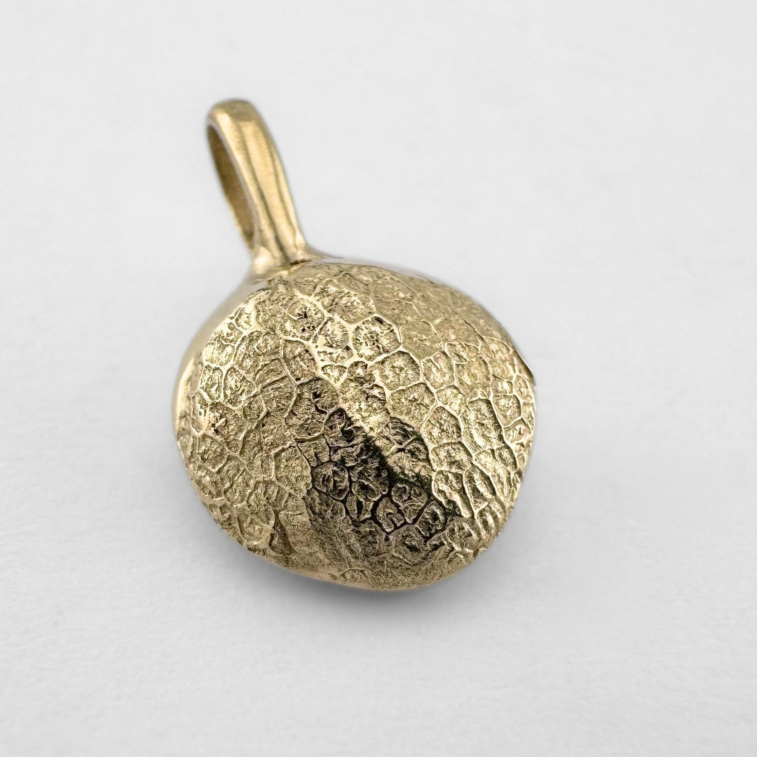 Gold dogs nose print pendant on light grey background