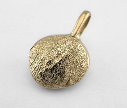 Gold dogs nose print pendant on light grey background