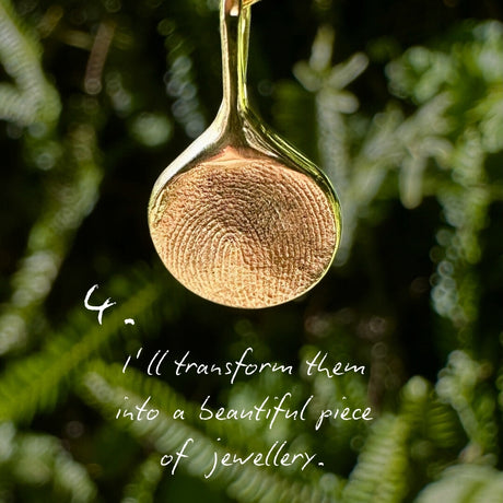 Close-up of gold fingerprint impression pendant