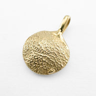 Gold dog's paw print pendant on light grey background