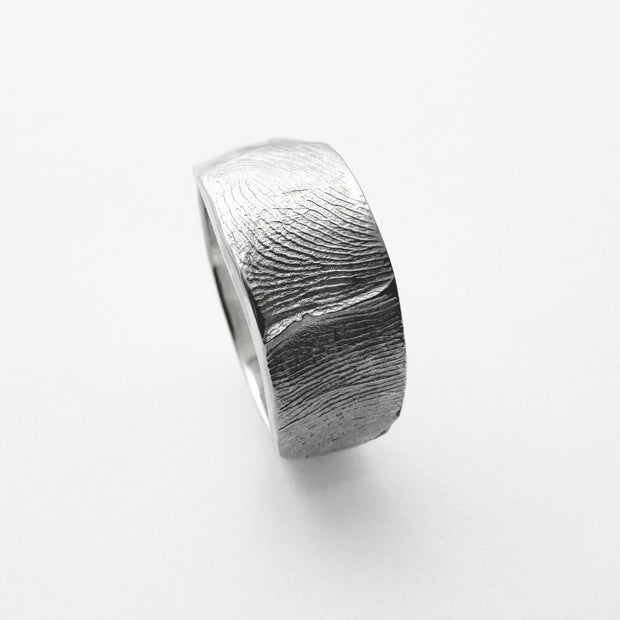 Silver Fingerprint ring band on light grey background