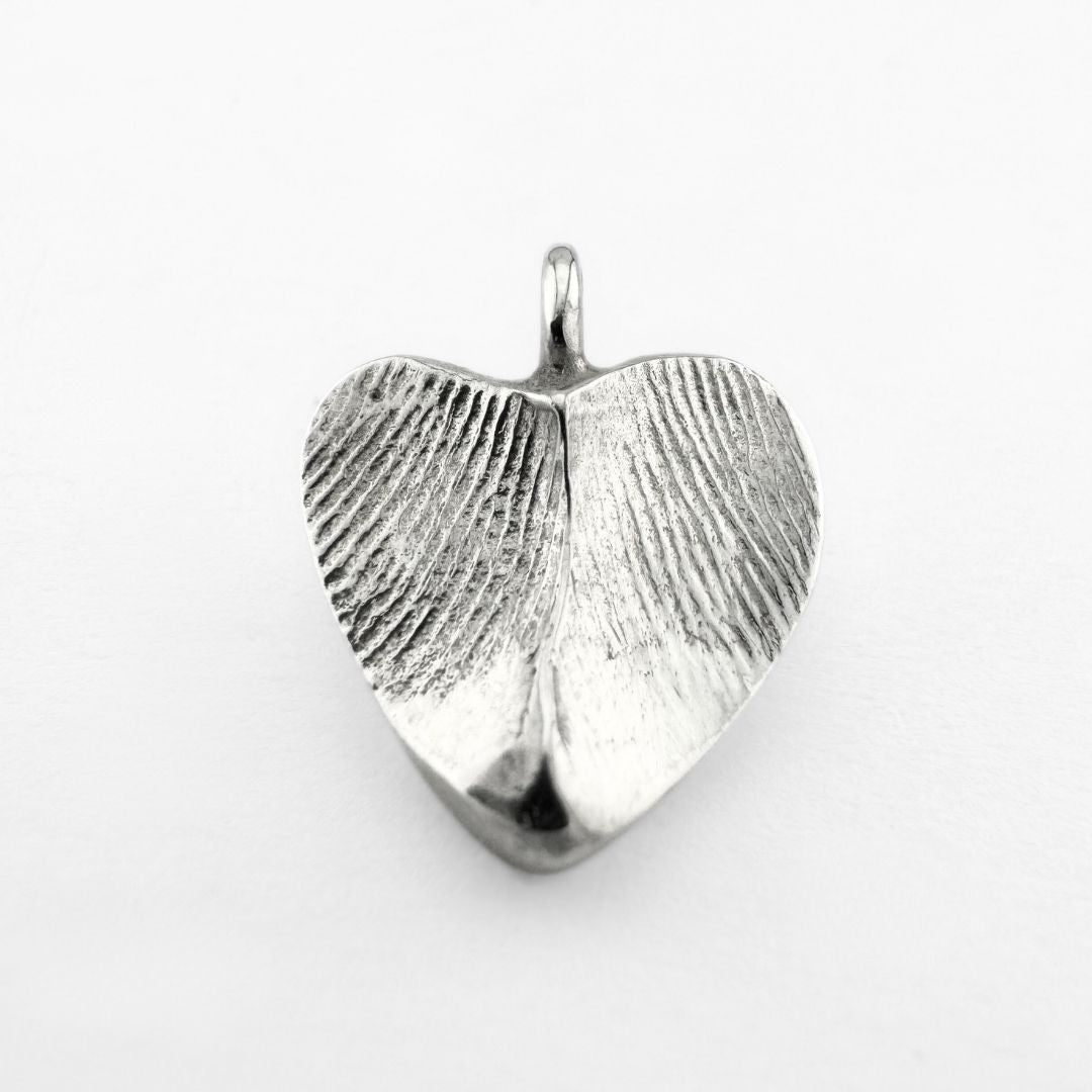 Silver double-sided fingerprint pendant on light grey background