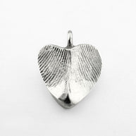 Silver double-sided fingerprint pendant on light grey background