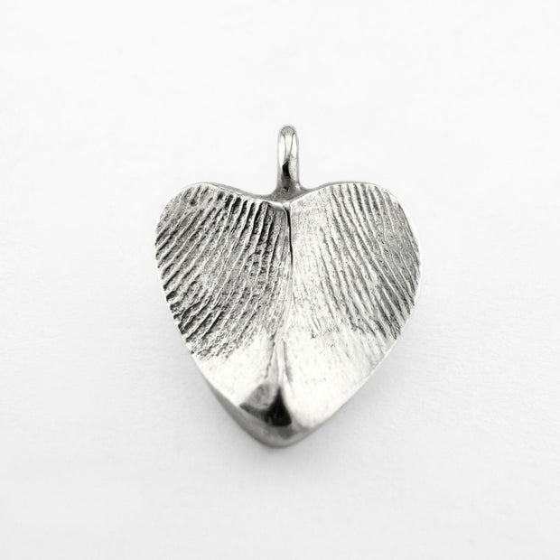 Silver double-sided fingerprint pendant on light grey background