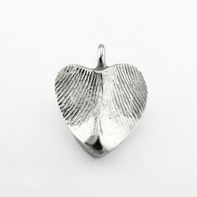 Silver double-sided fingerprint pendant on light grey background