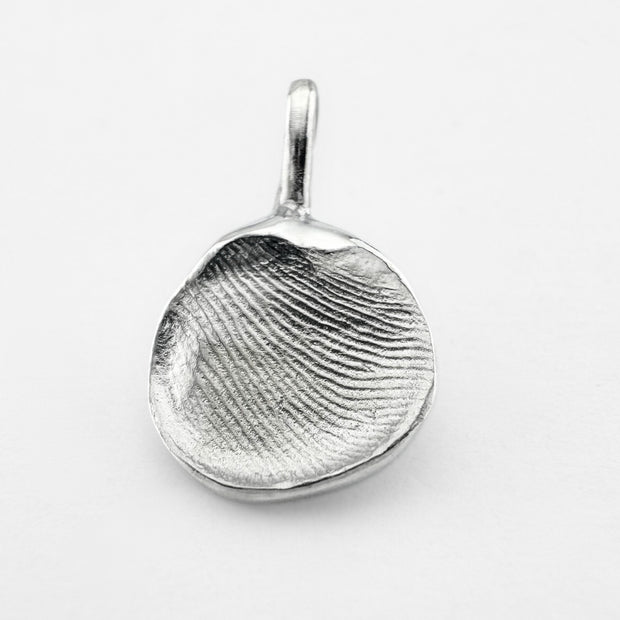 Silver fingerprint pendant on light grey background