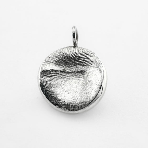 Silver Infant fingerprint pendant on light grey background