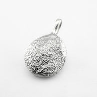 Silver dog's nose print pendant on light grey background