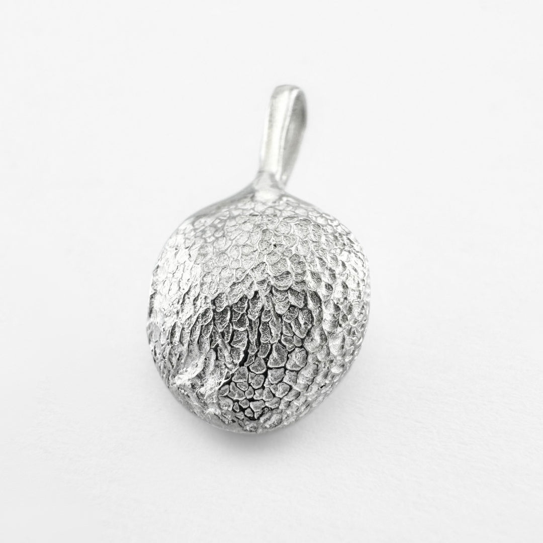 Silver paw print pendant on light grey background
