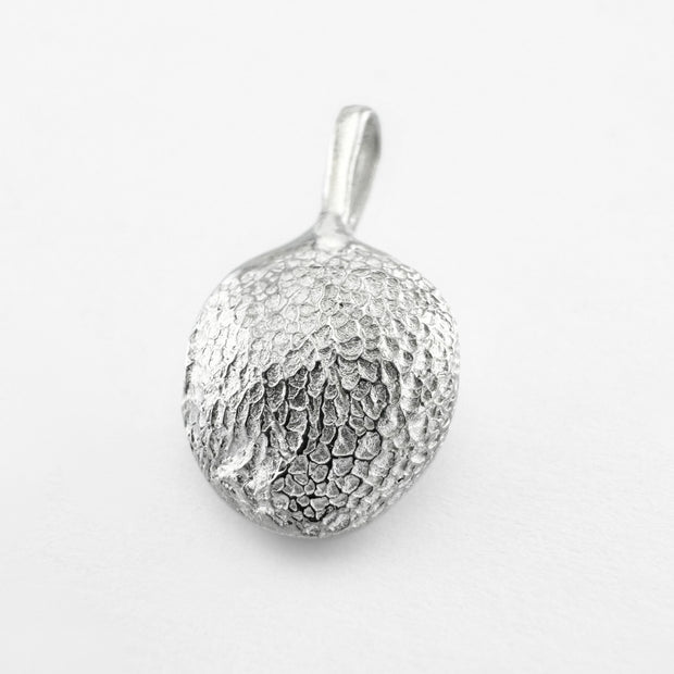 Silver paw print pendant on light grey background