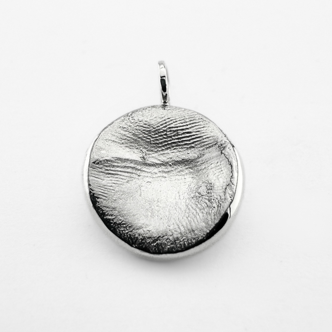 Silver fingerprint pendant on light grey background