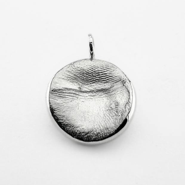 Silver fingerprint pendant on light grey background