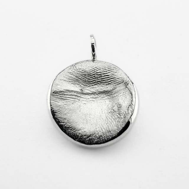 Silver fingerprint pendant on light grey background