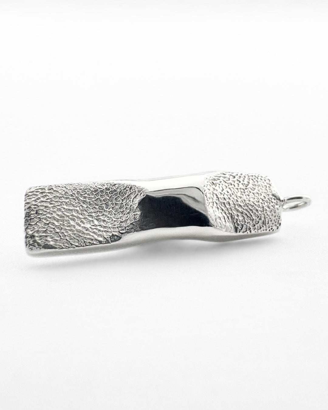 Rectangular silver pendant with a dog's paw print impression
