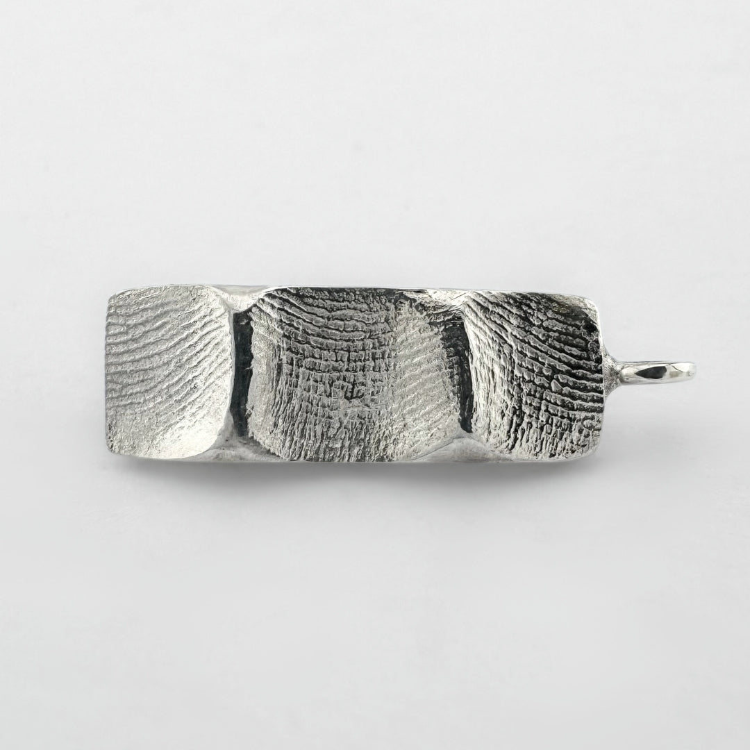 Sterling silver family fingerprint pendant on light grey background