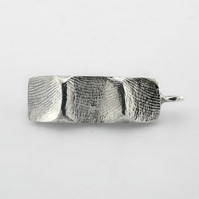 Sterling silver family fingerprint pendant on light grey background