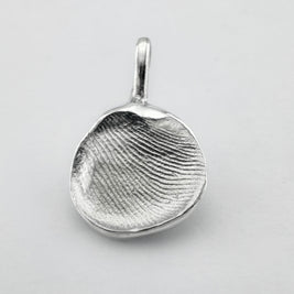 Sterling silver fingerprint pendant on light grey background