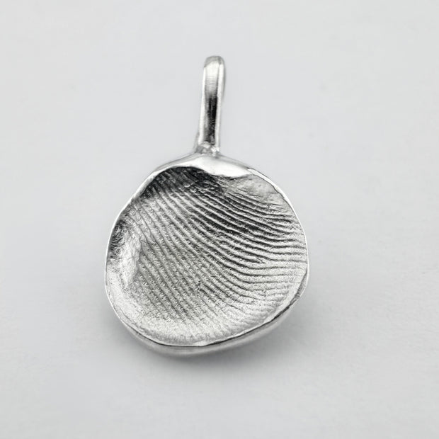 Sterling silver fingerprint pendant on light grey background