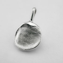 Sterling silver fingerprint pendant on light grey background