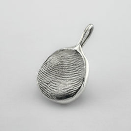 Sterling silver fingerprint pendant on light grey background