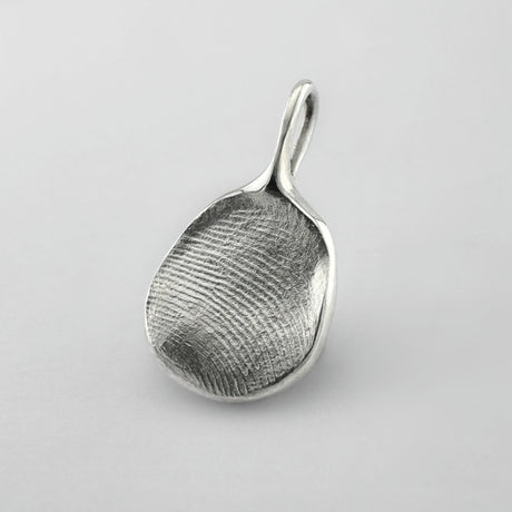 Sterling silver fingerprint pendant on light grey background