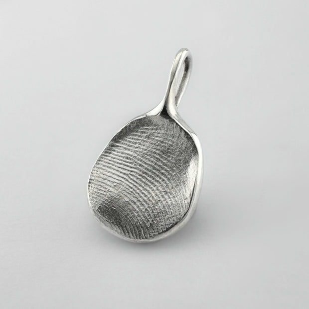 Sterling silver fingerprint pendant on light grey background
