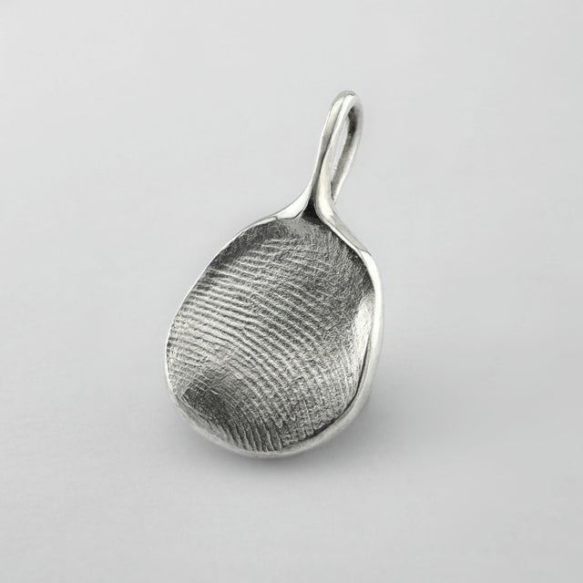 Sterling silver fingerprint pendant on light grey background