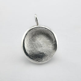 Sterling silver dogs nose print pendant on light grey background