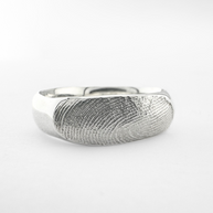 Silver fingerprint ring band on light grey background