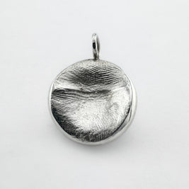 Sterling silver fingerprint pendant on light grey background