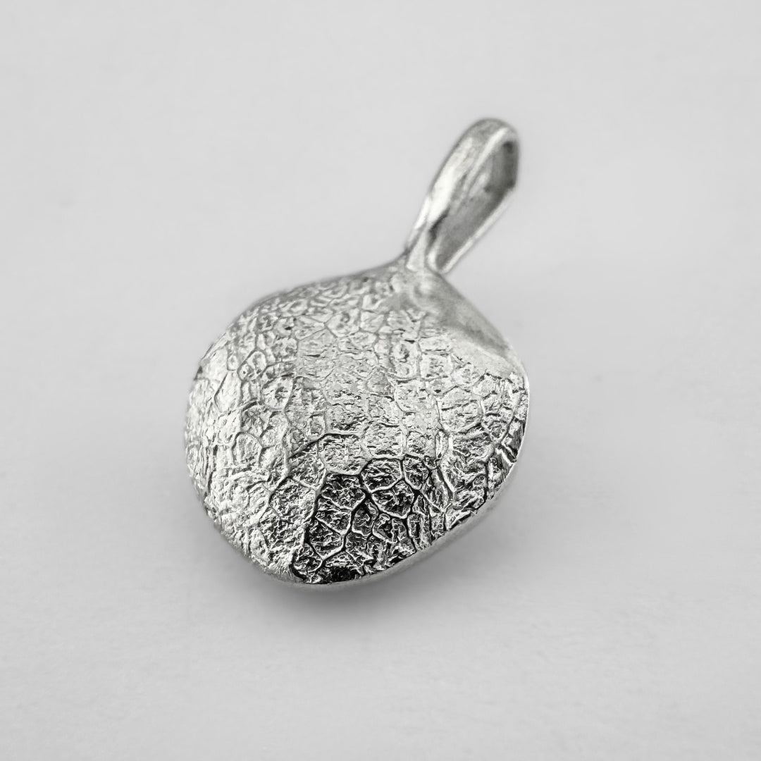 Sterling silver dogs nose print pendant on light grey background
