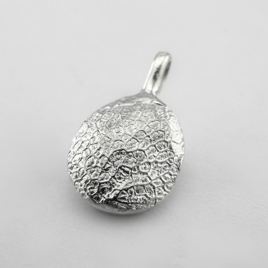 Sterling silver dogs nose print pendant on light grey background