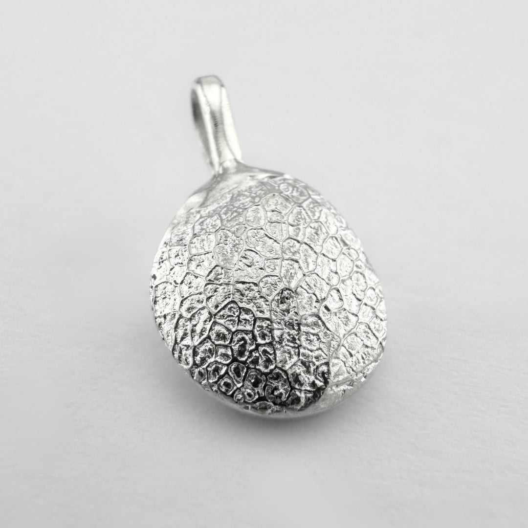 Sterling silver dogs nose print pendant on light grey background