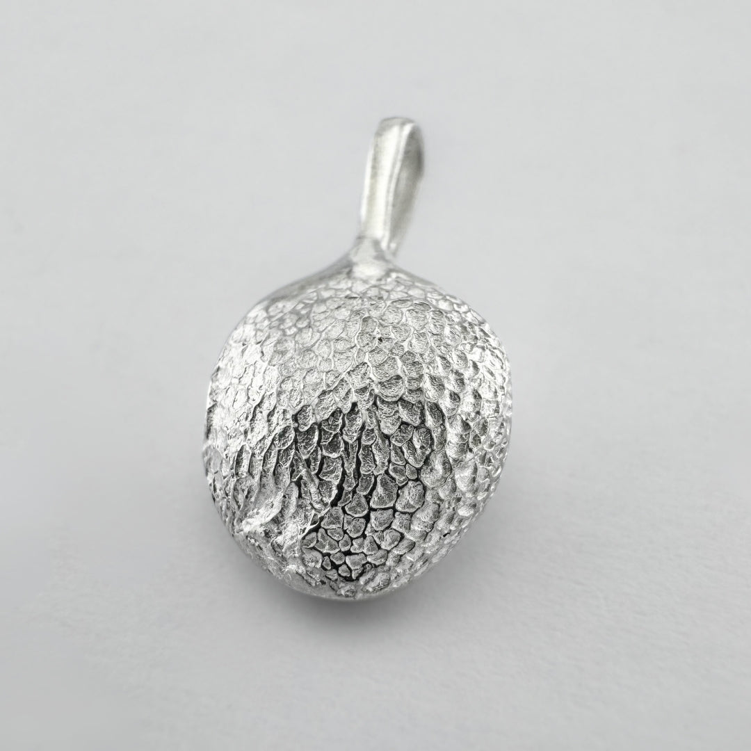 Sterling silver dogs paw print pendant on light grey background