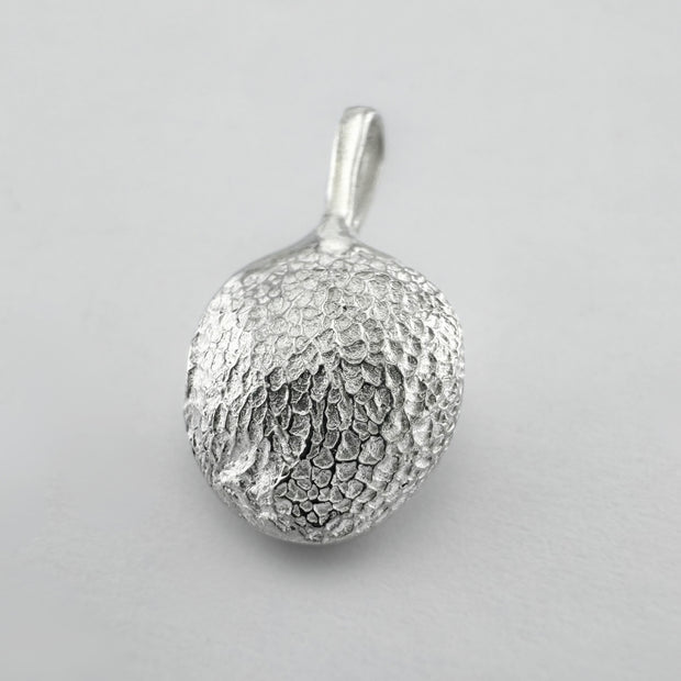 Sterling silver dogs paw print pendant on light grey background