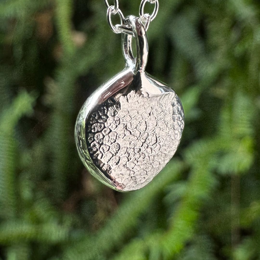 Close up of silver dogs nose print pendant