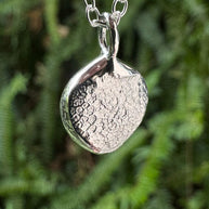 Close up of silver dogs nose print pendant