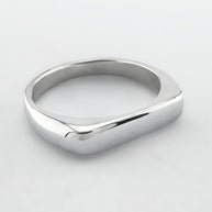 Thin silver signet ring on a light grey background