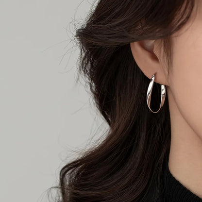 Lady wearing Twisted Sterling Silver Hoop Earrings