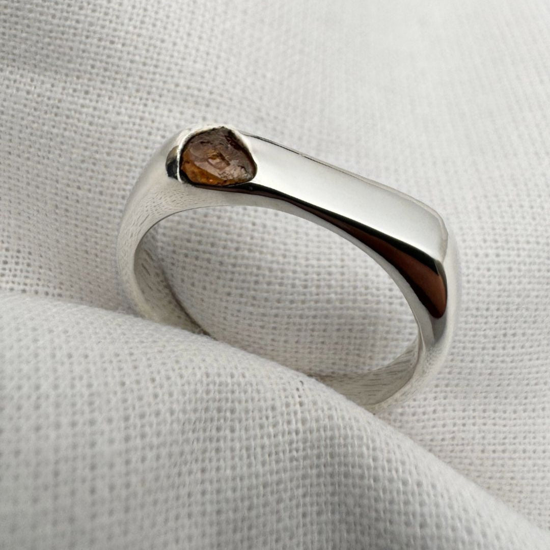 Thin silver signet ring with rough sapphire